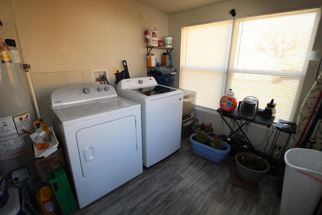 laundry room with dark wood-type flooring, laundry area, water heater, and independent washer and dryer