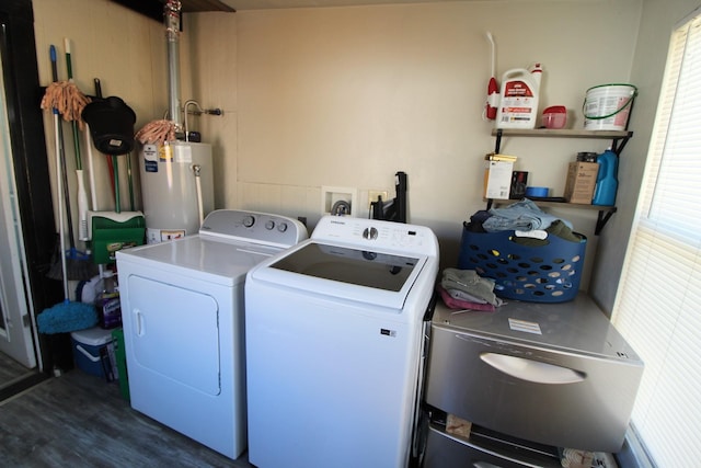 laundry area featuring gas water heater, dark wood-style flooring, a wealth of natural light, washing machine and dryer, and laundry area