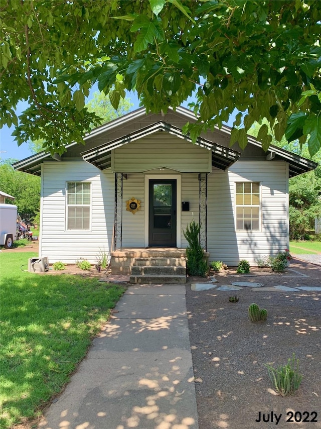 bungalow with a front yard