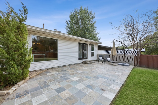 view of patio featuring fence and french doors