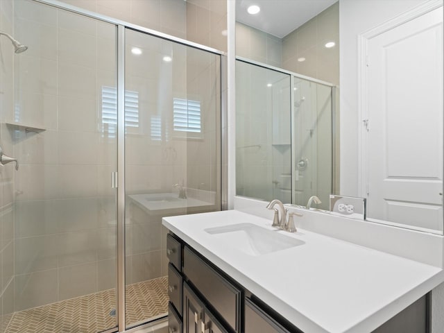 bathroom featuring a shower stall and vanity