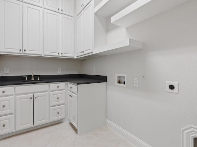 washroom with hookup for a washing machine, hookup for a gas dryer, cabinet space, a sink, and electric dryer hookup