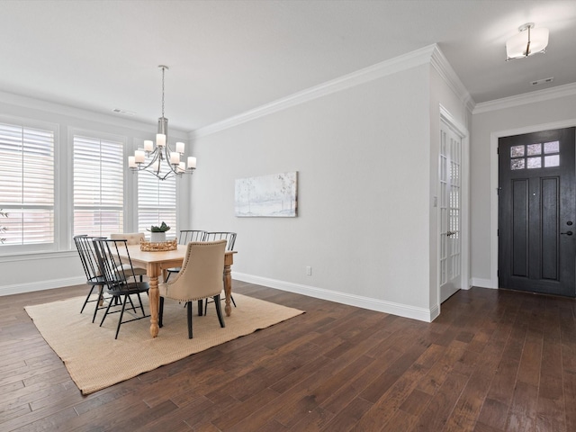 dining room featuring crown molding, a notable chandelier, dark wood finished floors, and baseboards