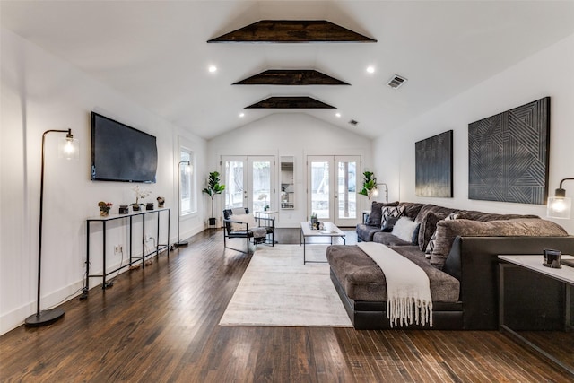 living area with baseboards, visible vents, wood finished floors, french doors, and high vaulted ceiling