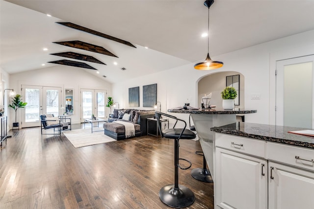 interior space featuring dark wood-style floors, french doors, recessed lighting, high vaulted ceiling, and beamed ceiling