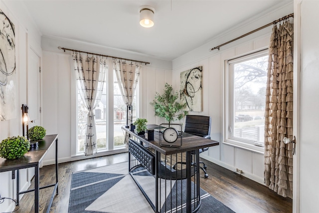 office space with wood finished floors and a decorative wall