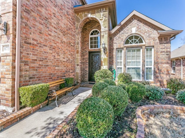 doorway to property with brick siding