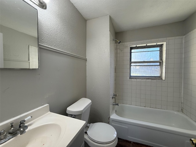 full bath featuring a textured wall, toilet, a textured ceiling, shower / tub combination, and vanity