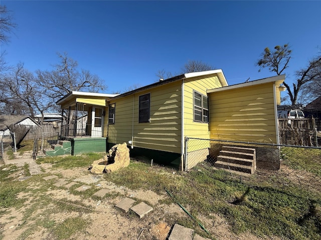 view of side of home featuring fence