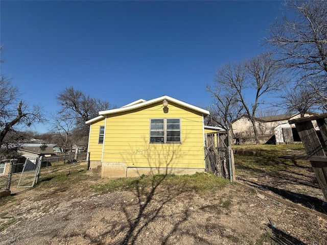 view of side of home with fence