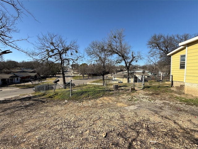 view of yard featuring fence and a residential view