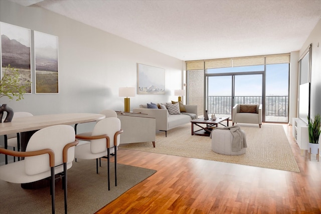 living room with a textured ceiling, expansive windows, and wood finished floors