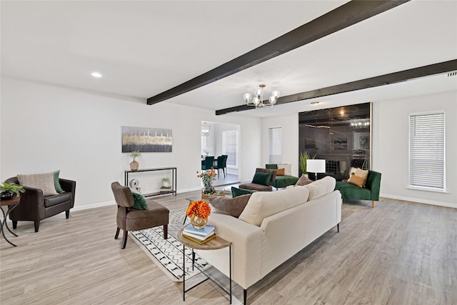 living area featuring recessed lighting, an inviting chandelier, light wood-type flooring, beamed ceiling, and baseboards