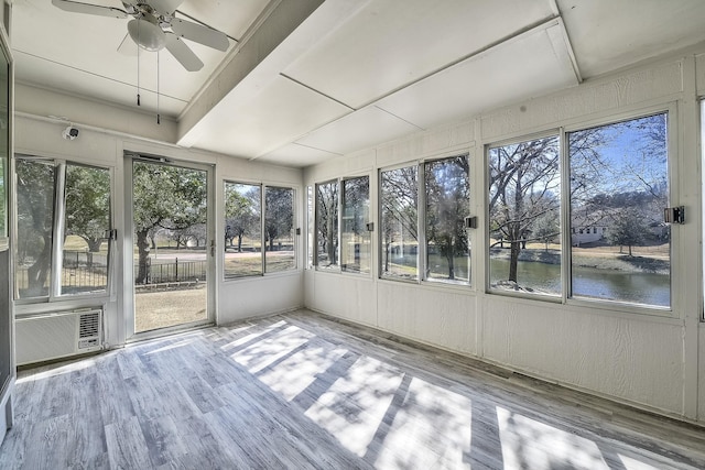 unfurnished sunroom featuring a water view and ceiling fan