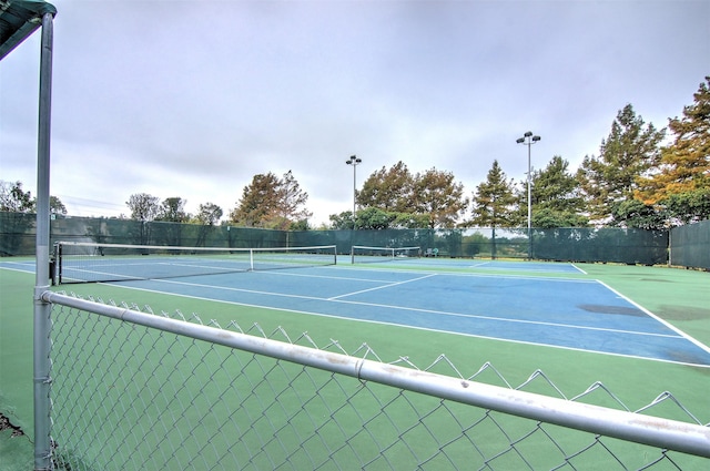 view of tennis court with fence