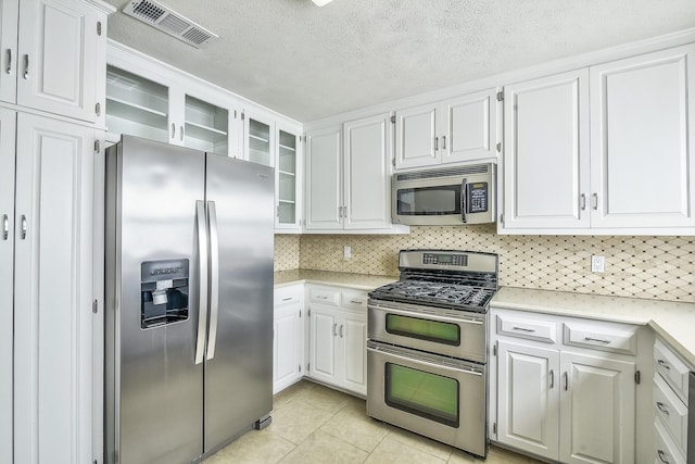 kitchen with white cabinetry, visible vents, appliances with stainless steel finishes, and light countertops