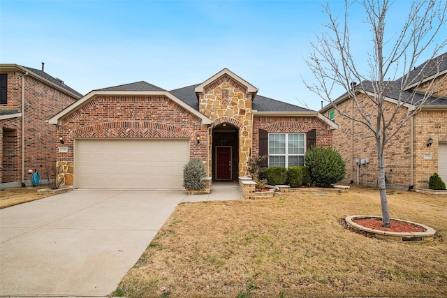 view of front of property featuring brick siding, a shingled roof, an attached garage, stone siding, and driveway