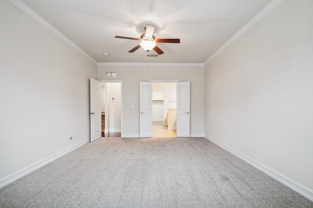 unfurnished bedroom with visible vents, crown molding, and light colored carpet