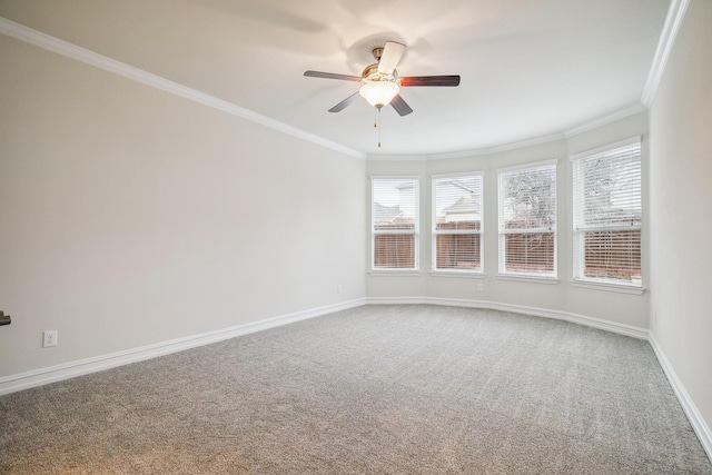 carpeted empty room with ornamental molding, a wealth of natural light, and baseboards