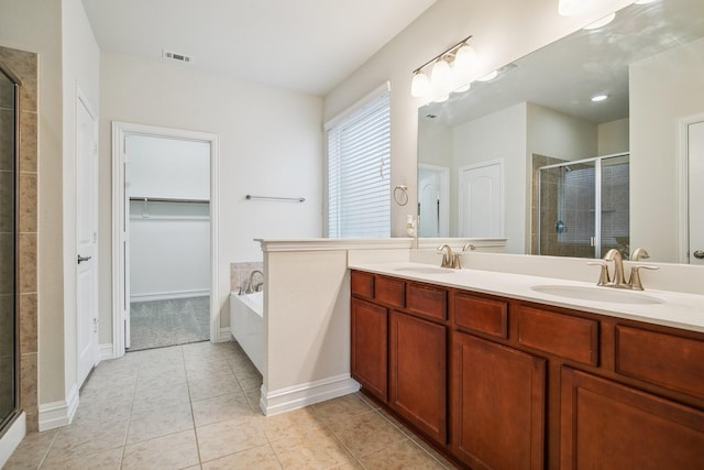 bathroom featuring a stall shower, a sink, visible vents, and tile patterned floors