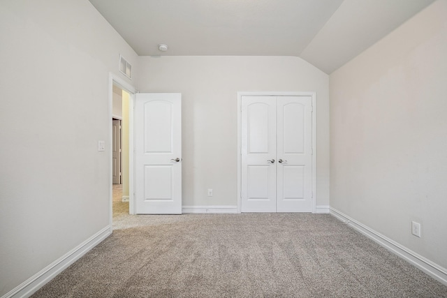 unfurnished bedroom with carpet, visible vents, and baseboards