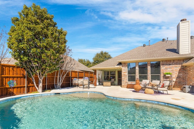 view of pool featuring an outdoor hangout area, a patio, and a fenced backyard