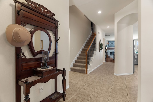 interior space with baseboards, recessed lighting, a fireplace, and tile patterned floors