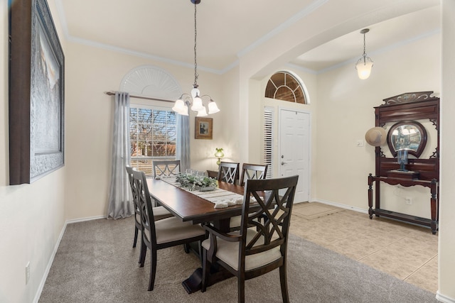 dining space featuring arched walkways, crown molding, baseboards, and light tile patterned floors