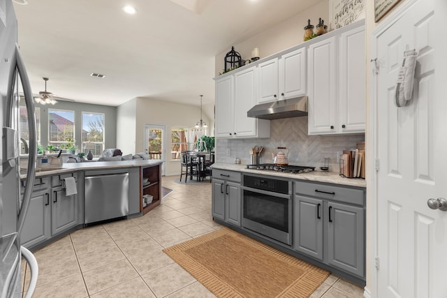 kitchen featuring light countertops, appliances with stainless steel finishes, white cabinets, and under cabinet range hood