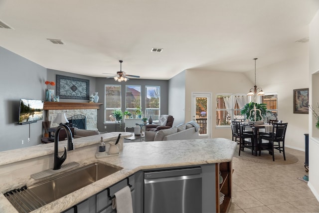 kitchen with pendant lighting, visible vents, open floor plan, a sink, and dishwasher