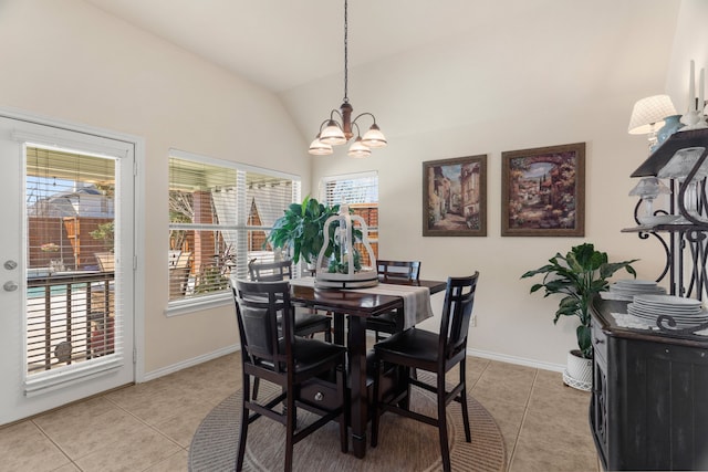 dining space featuring lofted ceiling, an inviting chandelier, a wealth of natural light, and light tile patterned flooring