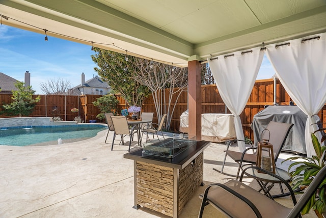 view of patio featuring a fenced in pool, an outdoor fire pit, and a fenced backyard