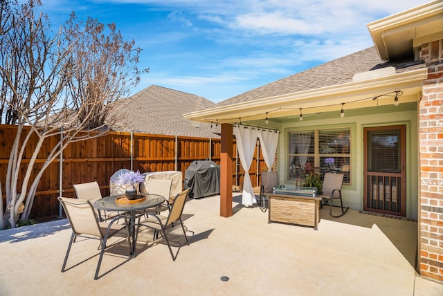 view of patio / terrace with outdoor dining space, grilling area, and fence