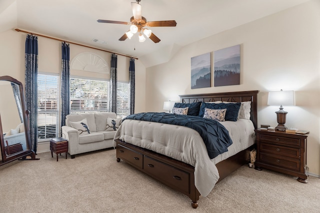 bedroom with a ceiling fan, visible vents, vaulted ceiling, and light carpet