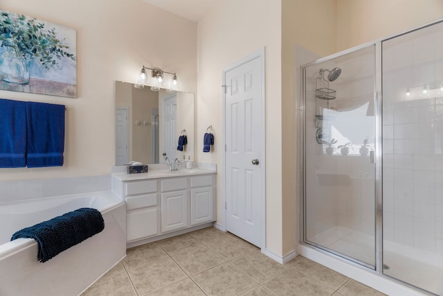 bathroom with a bath, a stall shower, vanity, and tile patterned floors