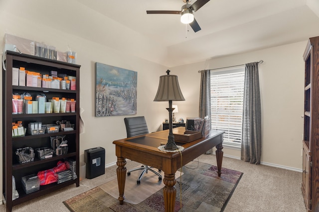 office area with light carpet, a ceiling fan, and baseboards