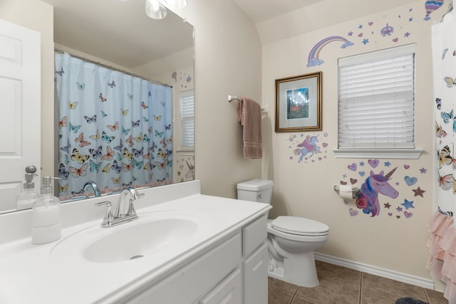 bathroom featuring baseboards, vanity, toilet, and tile patterned floors