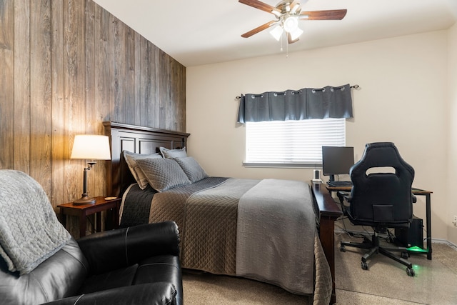 bedroom featuring carpet, ceiling fan, and wooden walls