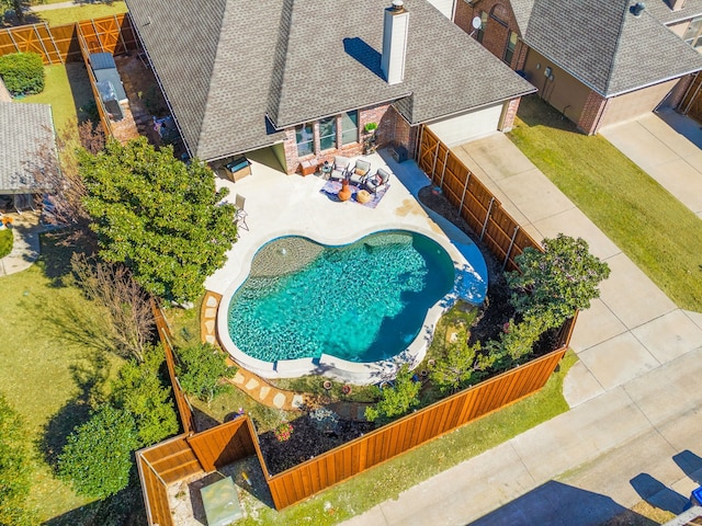 view of pool with a fenced backyard and a patio