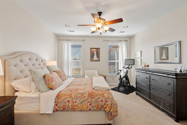 bedroom with light carpet, multiple windows, visible vents, and baseboards