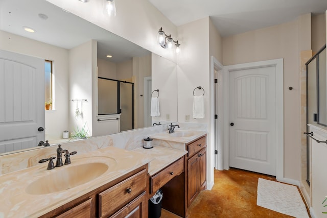 bathroom featuring a stall shower, a sink, and double vanity