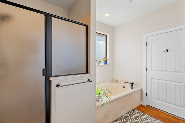 bathroom with a stall shower and a bath