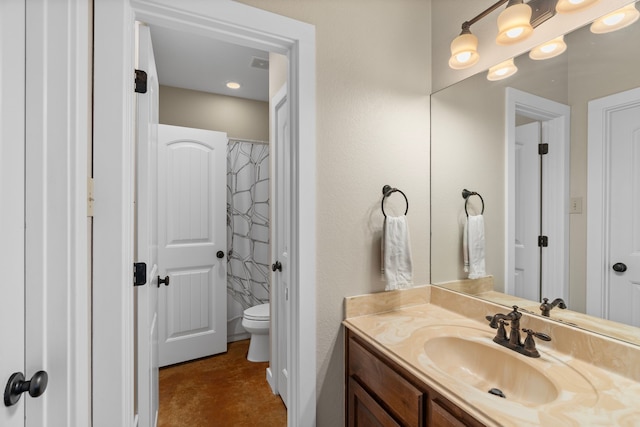 bathroom with vanity and toilet