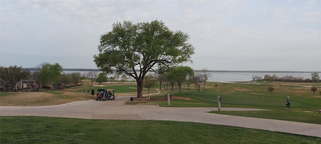 1571 Coastal Dr, Rockwall, TX 75087 - view of property's community featuring a water view, a yard, a putting green, and view of golf course