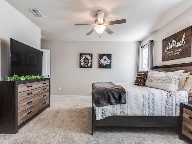 carpeted bedroom with a ceiling fan, visible vents, and baseboards