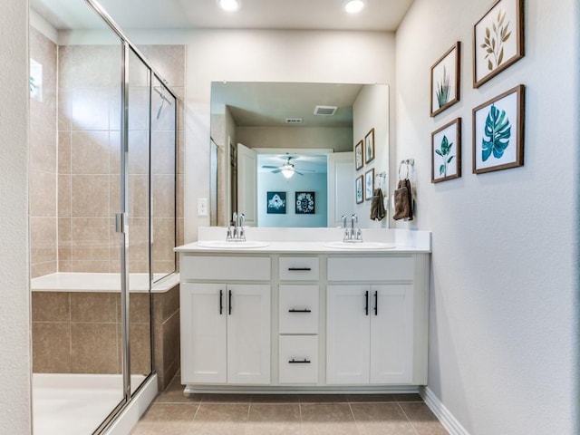 bathroom featuring visible vents, a sink, and a shower stall