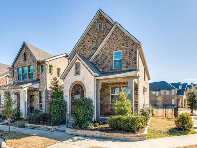 view of front of property with stone siding, brick siding, and fence