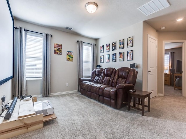 living room featuring carpet flooring, visible vents, and baseboards