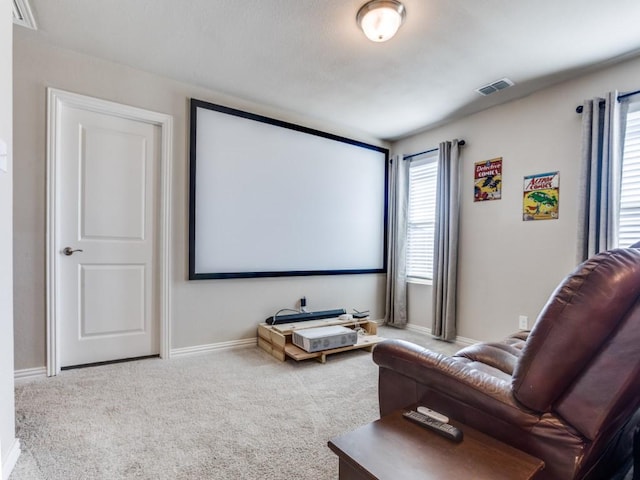 home theater room featuring carpet, visible vents, and baseboards