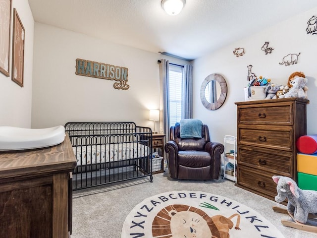 bedroom featuring carpet floors and a crib